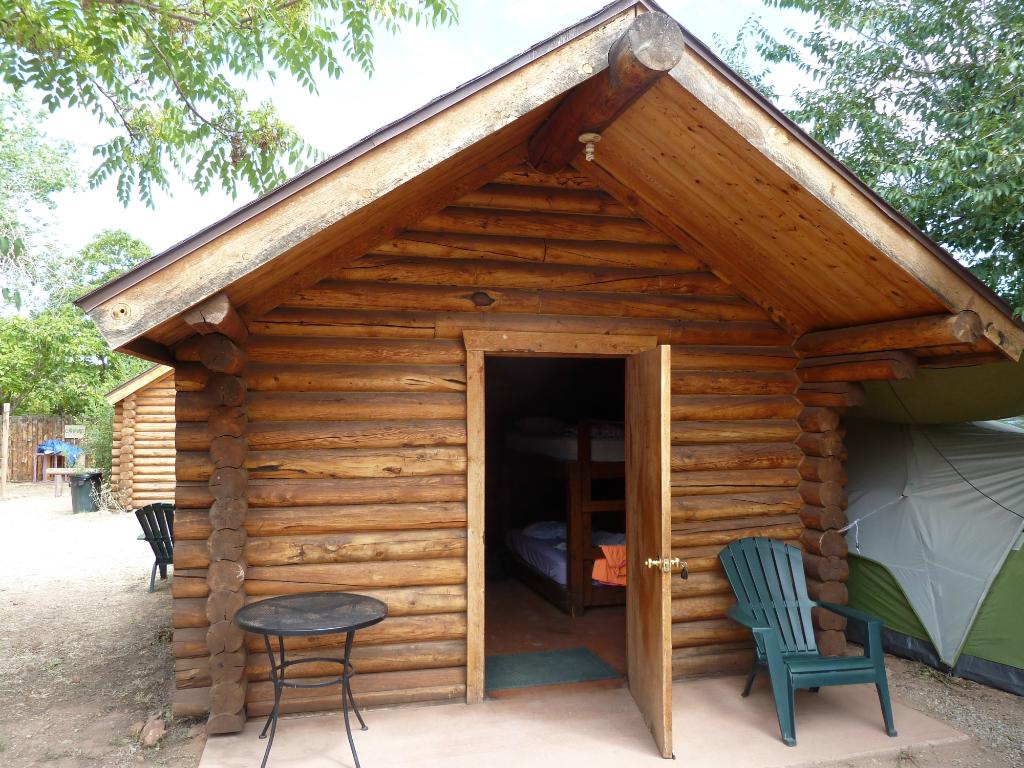 Log cabin entrance at the Lazy Lizard Hostel